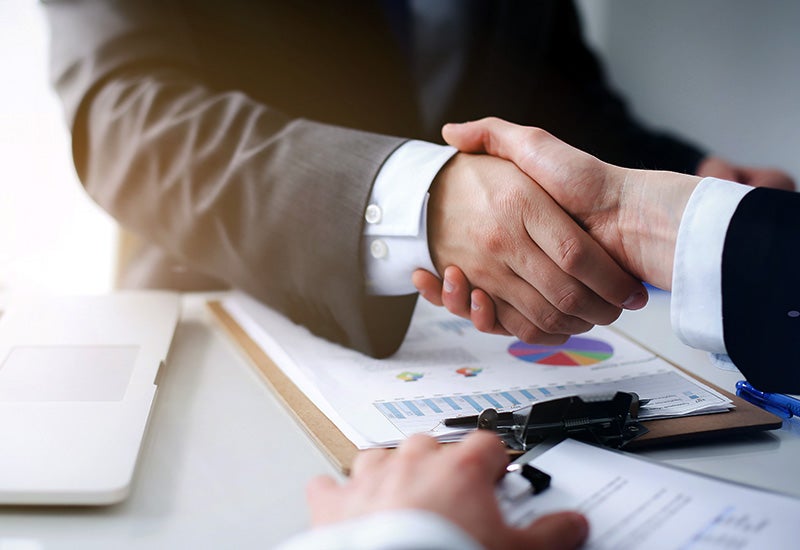 Finance handshake during Mazda vehicle purchase