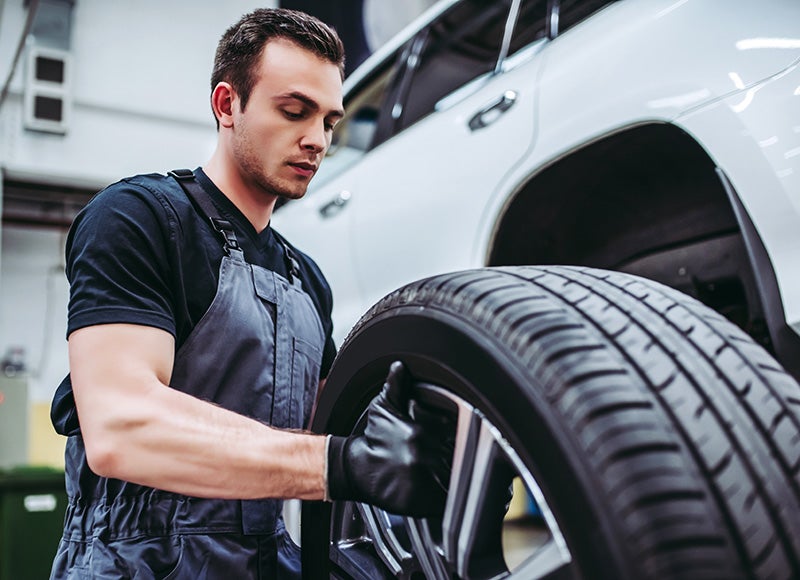 Service technician changing tires